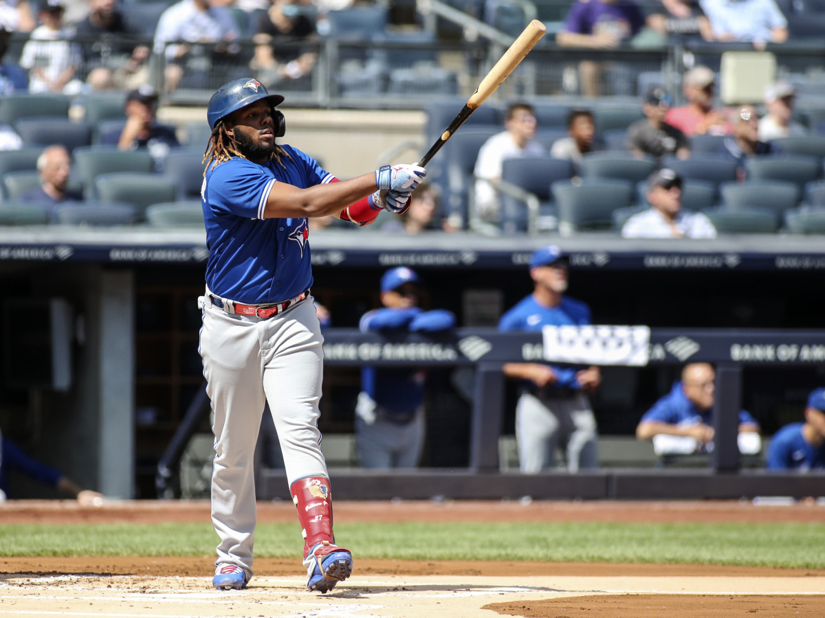 Sep 6, 2021; Bronx, New York, USA; Toronto Blue Jays first baseman Vladimir Guerrero Jr. (27) hits a solo home run in the first inning against the New York Yankees at Yankee Stadium.